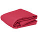 A stack of folded hot pink rectangular table covers on a white background.