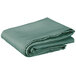 A stack of folded seafoam green Intedge table covers on a white background.