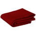 A stack of red folded Intedge square table covers.