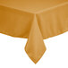 A square gold polyester tablecloth on a table.