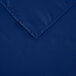 A folded square royal blue rectangular cloth table cover with a hemmed edge.