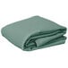 A stack of folded seafoam green Intedge rectangular table covers.