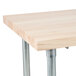 An Advance Tabco wood top work table with a galvanized metal base.