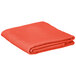 An orange folded Intedge square table cover on a white background.