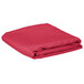 A folded hot pink rectangular table cover.