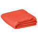 A folded orange Intedge rectangular cloth table cover.