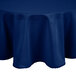 A royal blue Intedge round tablecloth on a table.