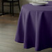 A purple Intedge tablecloth on a round table.