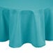 A teal round tablecloth on a round table.
