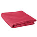 A folded hot pink Intedge round table cover.