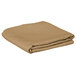 A folded beige Intedge polyester table cover.