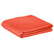 An orange folded Intedge square table cover.