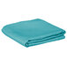 A folded teal blue Intedge cloth table cover.