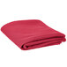 A folded hot pink polyester table cover on a white background.