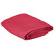 A folded hot pink Intedge cloth table cover on a white background.