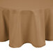 A beige Intedge round tablecloth on a table.
