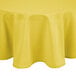 A yellow Intedge cloth table cover on a round table.
