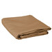 A folded beige Intedge cloth table cover.