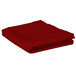 A folded red Intedge square table cover.