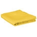 A yellow folded cloth table cover.