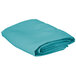 A folded teal square table cover on a white background.