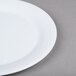 A white GET Centuria melamine plate on a gray surface.
