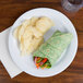 A white Centuria melamine plate with a tortilla wrap and chips.