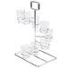 A chrome GET tower dessert shot display stand with six clear glasses on it.