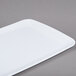 A white rectangular melamine display tray with a patterned design.