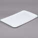 A white rectangular melamine display tray with a handle.