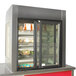 A Delfield drop-in horizontal air curtain merchandiser with glass doors on a counter.