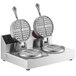 A Nemco dual waffle maker on a stand making two round waffles.