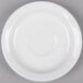 A Tuxton bright white narrow rim china demitasse saucer on a white surface.