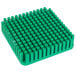 A green plastic square push block with rows of small squares.