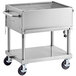 A large stainless steel barbecue grill on wheels.