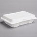 A white Dart foam takeout container with a perforated hinged lid.