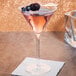 A Reserve by Libbey martini glass filled with a pink drink and garnished with blackberries.
