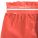 A coral orange plastic table skirt with a white strip.