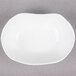 A 10 Strawberry Street bright white porcelain small elliptical dish with a small rim.