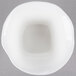 A white round porcelain bowl with a square base.