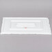 A white rectangular box with a red 10 Strawberry Street logo containing a white rectangular slate textured porcelain tray.