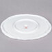 A bright white porcelain oval platter with a spiral cut edge.
