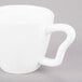 A close-up of a 10 Strawberry Street bright white porcelain cappuccino cup with a handle.