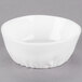 A white 10 Strawberry Street porcelain bowl with a small rim on a gray surface.