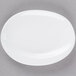 A 10 Strawberry Street bright white porcelain abalone plate with a small oval shape on it.