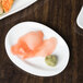 A close up of sashimi on a 10 Strawberry Street bright white porcelain plate.