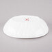 A bright white 10 Strawberry Street porcelain elliptical dish with a red sticker on the bottom.