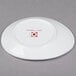 A white 10 Strawberry Street oval bone china plate with a red logo.