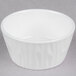A 10 Strawberry Street bright white porcelain ramekin with a wavy pattern on a gray surface.