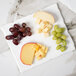 A 10 Strawberry Street bright white rectangular porcelain platter with cheese and grapes.